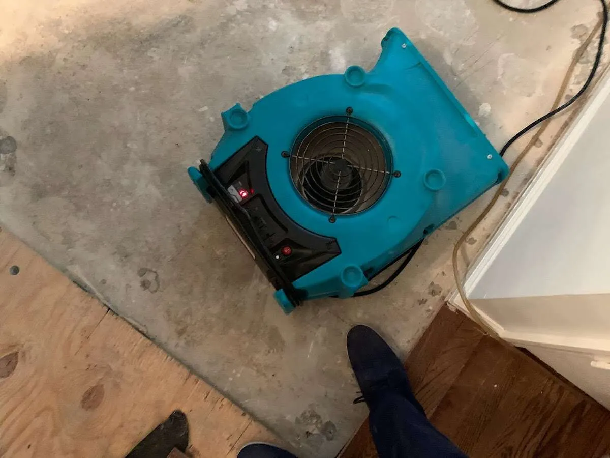 Air mover drying subfloor during Commercial Water Damage Restoration in Lynchburg, Moore County